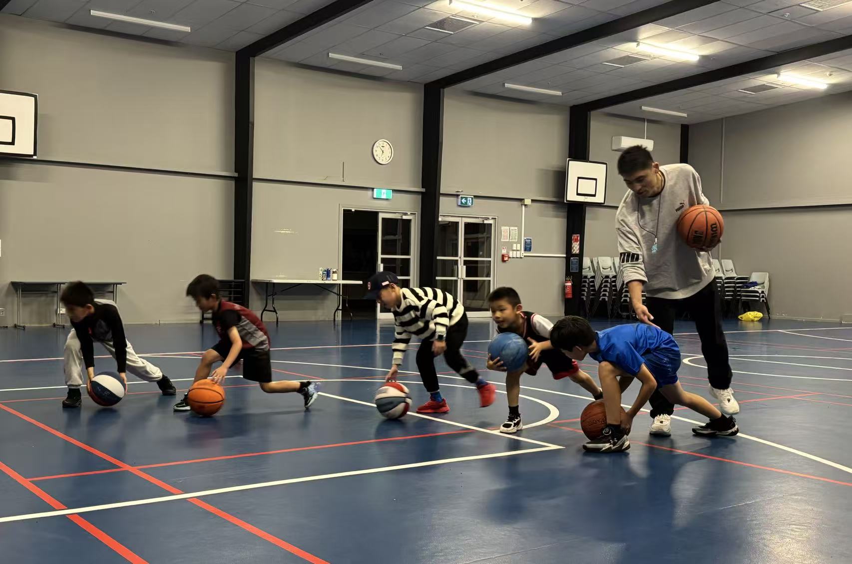 Coach leading a line of players in dribbling drills