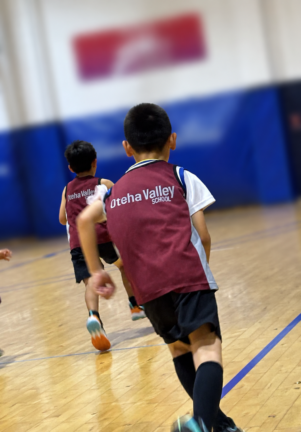 Children practicing basketball during a training session